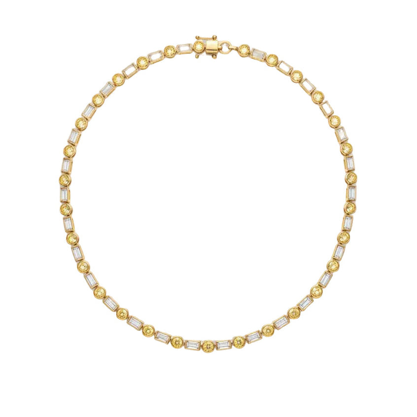 A yellow gold tennis necklace featuring baguette-cut white diamonds and round bezel-set yellow diamonds, arranged in a circular shape on a plain white background.