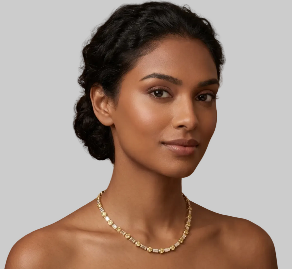 A yellow gold tennis necklace featuring baguette-cut white diamonds and round bezel-set yellow diamonds, arranged in a circular shape on a model.